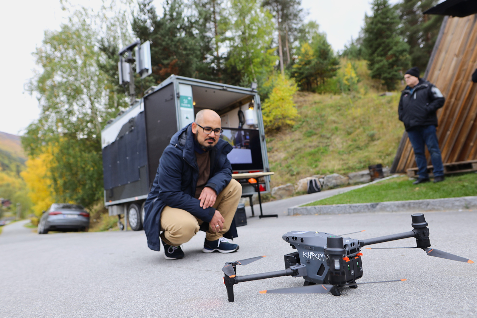 Man looking at drone on the ground